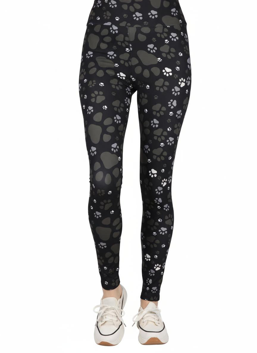 Black leggings with paw print pattern worn by a person on a white background