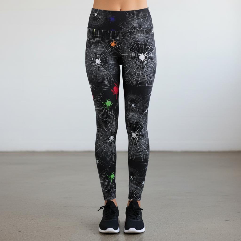 Leggings with spider web and spider design on a plain background