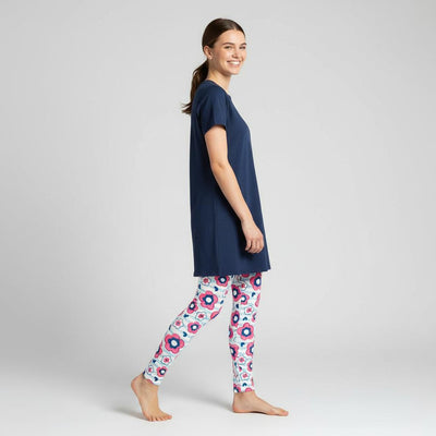 Woman wearing a navy blue t-shirt and daisypatterned leggings 
